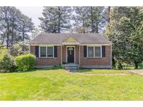 Charming brick home with a well-maintained lawn and traditional landscaping at 1951 Brannen Se Rd, Atlanta, GA 30316