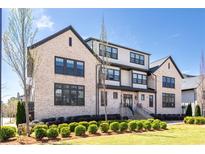 Beautiful multi-level brick home featuring manicured landscaping and black trim at 3905 Danube Ln # 215, Atlanta, GA 30339