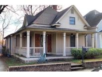 Charming home featuring a front porch with columns and a brick foundation at 698 Ira St, Atlanta, GA 30310