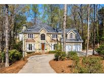 Charming two-story home boasts a well-manicured front yard and a classic architectural style at 290 Coles Hill Ct, Johns Creek, GA 30022