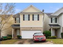 Inviting two-story home with attached garage and well-maintained lawn at 6389 Shadow Sq, Lithonia, GA 30058