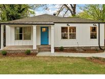 Charming white home with a bright blue front door and inviting front porch at 244 Birch St, Atlanta, GA 30354