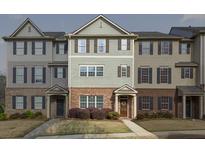 Attractive townhome with brick and siding facade, multiple windows and manicured lawn at 3920 High Dove Sw Way # 11, Smyrna, GA 30082