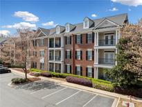 Three-story brick building with balconies and beautiful landscaping at 4955 Ivy Ridge Se Dr # 404, Atlanta, GA 30339