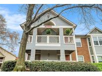 Charming multi-level home with double balconies, gray siding, brick accents, and a manicured green hedge at 708 Mcgill Ne Pl, Atlanta, GA 30312