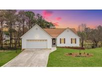 Charming home with white siding, brown roof, well-manicured lawn, and attached garage at 1340 Summer Lake Ter, Loganville, GA 30052