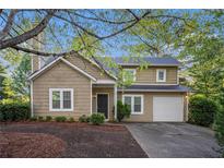 Charming two-story home featuring a front-entry garage and well-maintained landscaping at 1946 Glenwood Downs Dr, Decatur, GA 30035