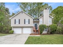 Charming two-story home with neutral siding, black shutters, and a two-car garage, set on a well-manicured lawn at 3380 Saddleton Way, Douglasville, GA 30134