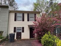 Charming two-story townhouse with neutral siding, dark shutters, and a well-maintained front yard at 3839 Henry Ct, Acworth, GA 30101