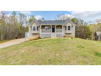 Charming home featuring a welcoming front porch and well-maintained lawn at 167 Fairview Oak Trl, Dallas, GA 30157