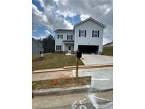 Two-story home features a two-car garage, landscaped yard, and classic black shutters at 803 Rock Hill Pkwy, Lithia Springs, GA 30122