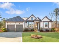 Charming home with a well-manicured lawn, a two-car garage, and appealing architectural details at 114 Montgomery Ln, Villa Rica, GA 30180