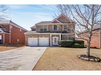 Charming two-story brick home with a two-car garage and well-maintained front yard in a suburban neighborhood at 3642 Sunbridge Dr, Snellville, GA 30039