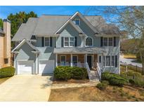 Charming two-story home featuring a well-manicured lawn and a two-car garage at 1460 Edgemont Pt, Lawrenceville, GA 30044