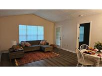 Cozy living room with modern furnishings and a large window offering natural light at 434 Bentley Place, Tucker, GA 30084