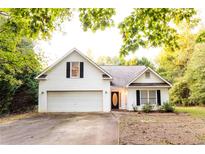 Charming home featuring a two-car garage, traditional siding, and inviting curb appeal at 355 Freeman Dr, Covington, GA 30016