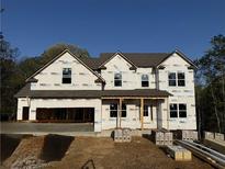 New construction home featuring a covered front porch and a two-car garage in a suburban neighborhood at 1078 Birch Way, Loganville, GA 30052