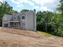 New two-story home with gray siding, brick accents, and an attached two-car garage at 1078 Birch Way, Loganville, GA 30052