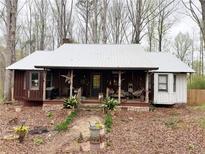 Charming single-story home with a rustic porch, metal roof, and stone foundation at 110 N River Rd, Mcdonough, GA 30252
