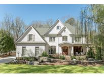 Stunning painted brick home featuring manicured landscaping and a charming front porch at 3224 Lanier Ne Dr, Atlanta, GA 30319