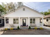 Charming home featuring a welcoming front porch, black front door, and beautifully landscaped front yard at 91 Chester Se Aly, Atlanta, GA 30316