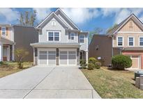 Charming two-story home features a two-car garage, stone accents, and a well-maintained front yard at 5780 Crestwick Way, Cumming, GA 30040