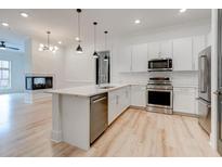Bright kitchen with stainless steel appliances, white cabinets, and an island that opens to the living room at 625 Piedmont Ne Ave # 2004, Atlanta, GA 30308