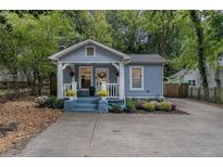 Charming blue home with a cozy front porch and beautifully landscaped front yard at 1812 Defoor Nw Ave, Atlanta, GA 30318