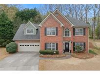 Charming two-story brick home with a manicured lawn and attached two-car garage at 1803 Gold Finch Way, Lawrenceville, GA 30043