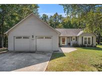 Charming single-story home with a two-car garage and well-maintained lawn at 5623 Yeager Dr, Douglasville, GA 30135