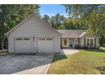 Charming single-story home with a two-car garage and well-maintained front yard at 5623 Yeager Ridge Dr, Douglasville, GA 30135
