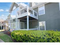 Inviting exterior of a two-story home with a balcony and manicured landscaping at 1005 Berkeley Woods Dr, Duluth, GA 30096