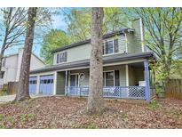 Charming home with a covered porch and attached two-car garage at 835 Ridge Ave, Stone Mountain, GA 30083
