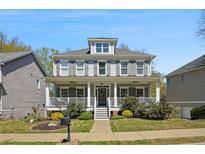 Charming two-story home with a welcoming front porch and manicured landscaping at 2241 Harry Brooks Nw Dr, Atlanta, GA 30318