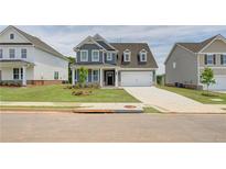 Charming two-story home featuring a manicured lawn, a two-car garage and a welcoming entryway at 255 Arnewood Cir, Mcdonough, GA 30253