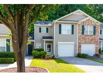 Charming townhome with attached garage, well-maintained lawn, and beautiful curb appeal at 137 Venture Path, Hiram, GA 30141
