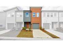 Inviting front exterior showcases a modern townhome with neutral colors and a one car garage at 1528 Parks Edge Nw Ln, Atlanta, GA 30318