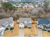 Charming two-story home in a desirable neighborhood with well-maintained landscaping and a private backyard at 1690 Geranium Ln, Cumming, GA 30040