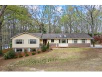 Charming ranch-style home featuring a well-maintained lawn and classic brick accents at 3595 Limberlost Sw Trl, Stockbridge, GA 30281