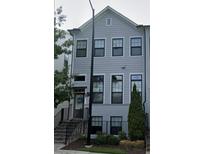 Charming two-story home featuring a symmetrical facade, multiple windows, and a landscaped front yard at 2026 Manchester Ne St, Atlanta, GA 30324