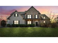 Charming brick and shingle home with a well-manicured lawn and inviting front porch at 5705 Windjammer Pt, Cumming, GA 30041