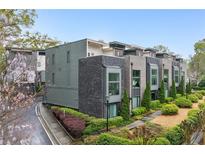 Modern townhome with sleek gray and brick facade, professional landscaping, and private drive at 728 Oakview Rd, Decatur, GA 30030