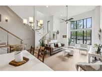 Open living space with a modern chandelier, staircase, and large windows for natural light at 728 Oakview Rd, Decatur, GA 30030