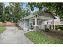 Charming bungalow-style home featuring a covered carport and a quaint front porch at 972 Sims Nw Ave, Atlanta, GA 30318