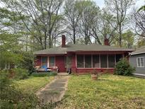 Charming brick home featuring a screened-in porch and mature trees in an established neighborhood at 349 Hopkins Sw St, Atlanta, GA 30310