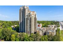 Stunning exterior view of two high-rise condo buildings nestled among lush green trees at 795 Hammond Dr # 1707, Atlanta, GA 30328