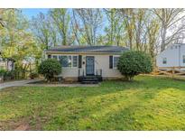 Charming single-story home featuring a well-maintained lawn and mature landscaping at 2070 Perkerson Sw Rd, Atlanta, GA 30310