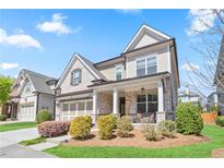 Charming two-story home featuring a combination of brick and siding, an attached garage, and a beautifully landscaped front yard at 11395 Crestview Ter, Johns Creek, GA 30024