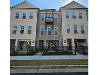Attractive townhome showcases brick facade, balcony, and fenced courtyard at 502 Clover Ln, Alpharetta, GA 30009
