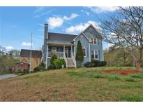 Charming two-story home features a covered porch and well-maintained landscaping at 524 Lambeth Dr, Hiram, GA 30141